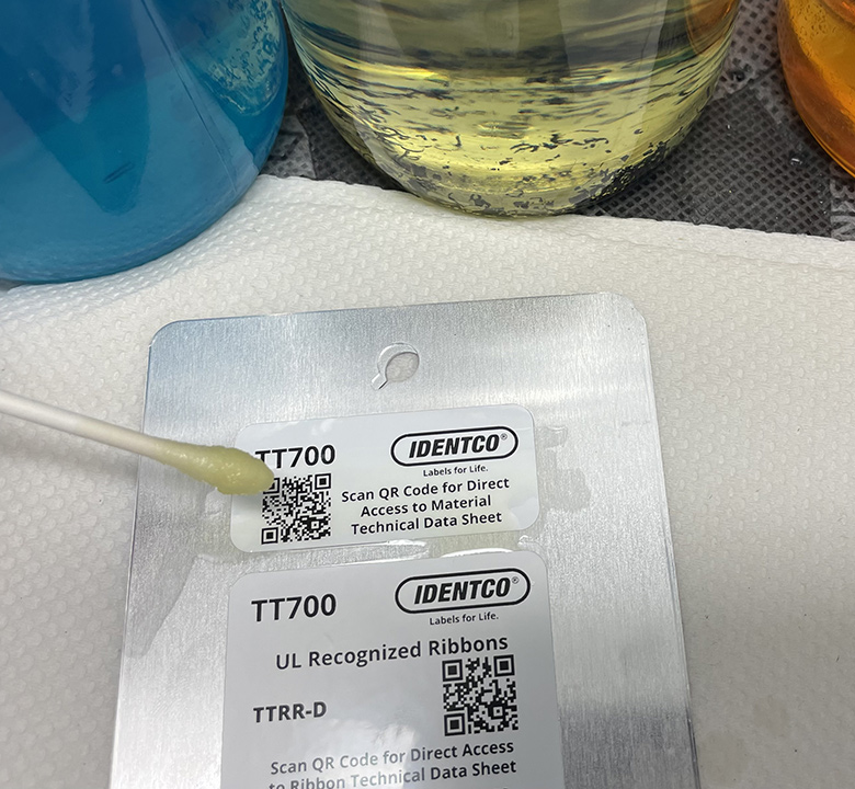 Picture of a label being wiped with chemicals.