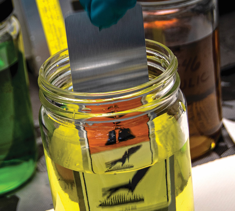 Picture of a label with hazardous materials information in a bottle with chemicals.