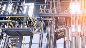A complex network of pipes and vessels in a modern chemical processing facility