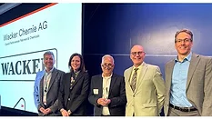 Picture of five people receiving award.