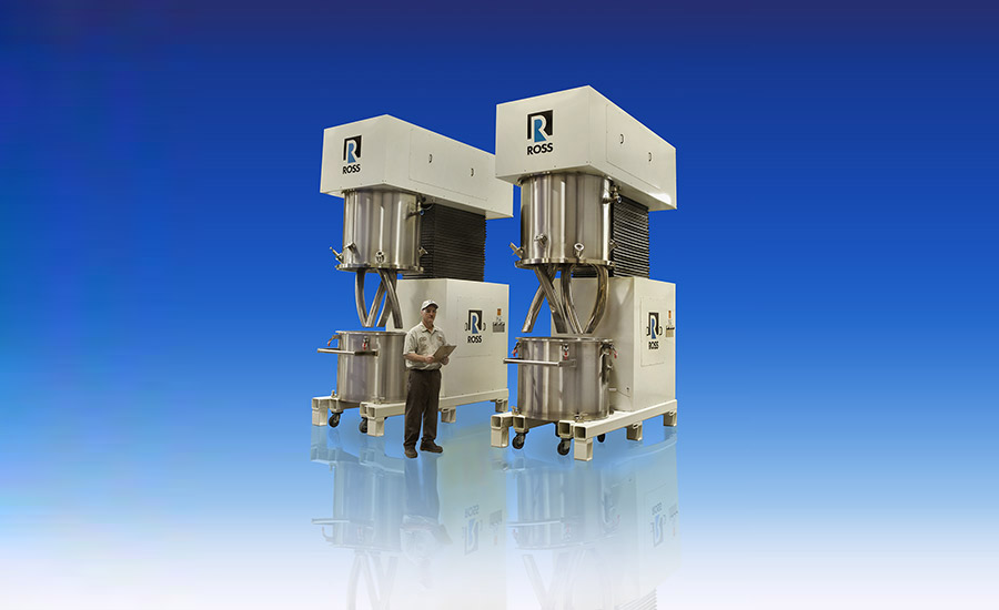 Photo of man standing next to two 200-gal model DPM-200 double-planetary mixers