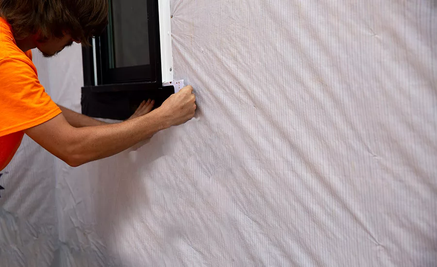 Photo of tape being installed around window