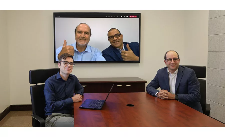 Photo of executives from IMCD and Quelaris signing acquisition agreement.