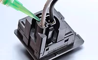 Photo of Master Bond epoxy encapsulant being applied to an electrical connection
