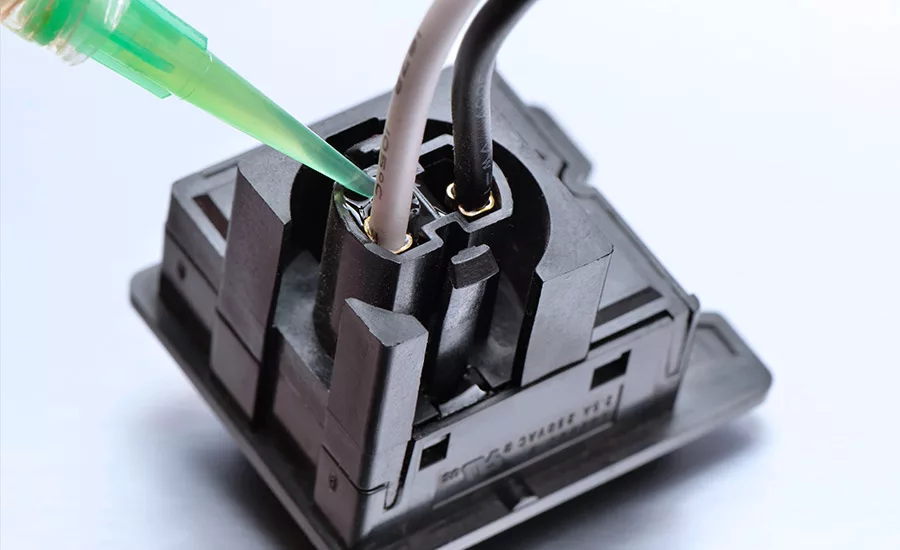 Photo of Master Bond epoxy encapsulant being applied to an electrical connection