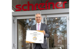 Photo of Roland Schreiner, CEO of Schreiner Group, displaying the EcoVadis Gold certification.
