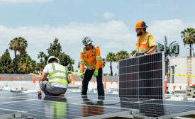 Image of people installing solar panels.