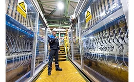 man in hard hat stands in chlorine electrolysis plant