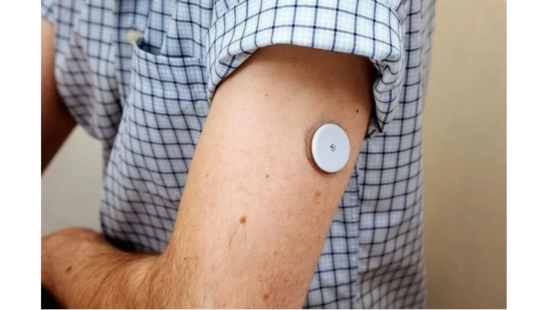 image of medical adhesive being used on a mans arm