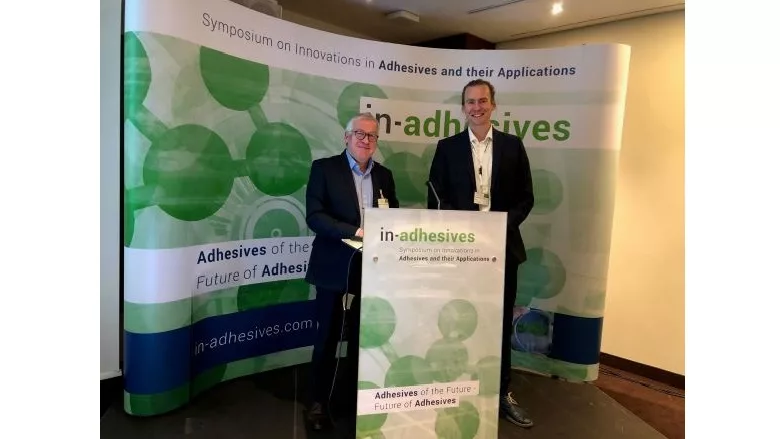 two people present at in-adhesives symposium