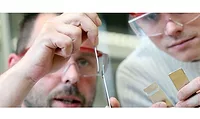 image of two people in saftey glasses working in a lab