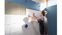 WACKER Polymeric Binders image of tiler tiling a wall
