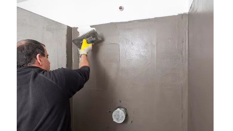 image of man using hydrophobic dispersions to re seal a structure