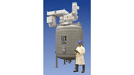 Picture of a man standing next to a very large dual-shaft mixer