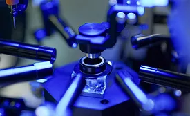 Image of an blue automotive camera lens being assembled