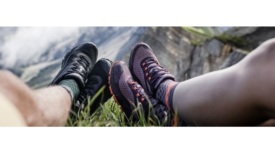 image of two hiker's feet dangling atop a mountain