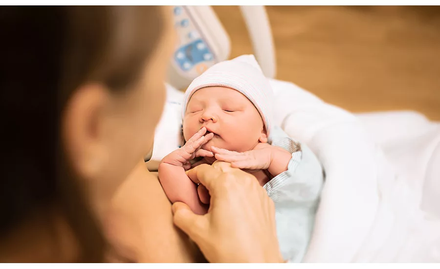 new born baby in mothers arms