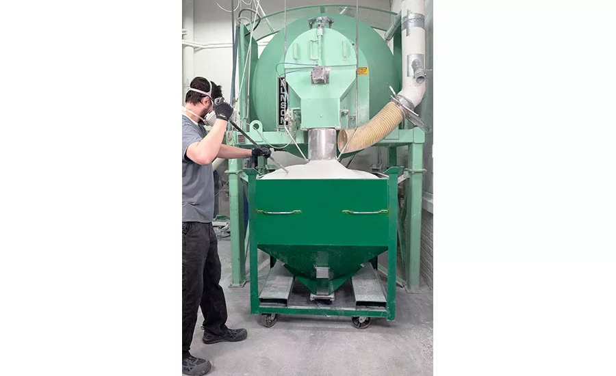 The mixer discharges uniformly blended product into a mobile bin