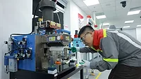 Henkel's Application Center in North Vietnam Photo of a person using an adhesive dispensing system
