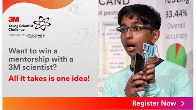 Picture of a young man holding an iphone with a device attached to it.