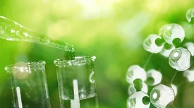 A close-up of a test tube with a green background