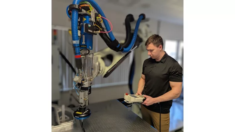 Picture of man standing next to dispensing machine