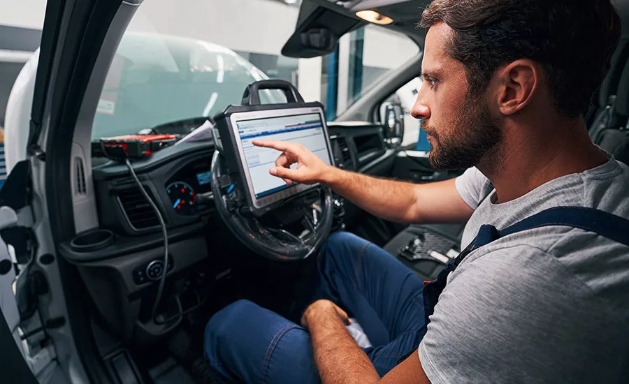 Man using touchscreen on car dashboard