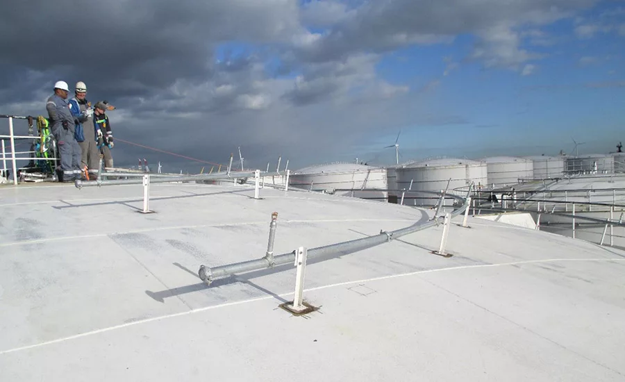 workers on top of industrial tank