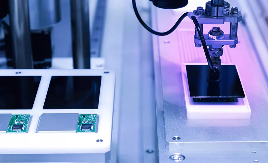 adhesive being applied to electronics