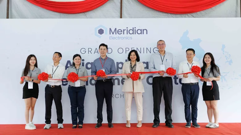 Picture of eight people standing in front of a ribbon