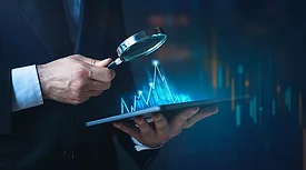 A person holding a tablet with a magnifying glass