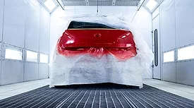automotive coating being applied in paint booth
