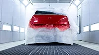 automotive coating being applied in paint booth