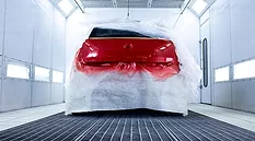 automotive coating being applied in paint booth