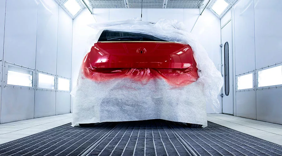automotive coating being applied in paint booth