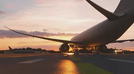 airplane taxing on runway at sunset
