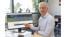 Picture of a man pointing to a computer