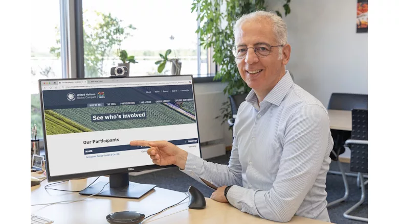 Picture of a man pointing to a computer