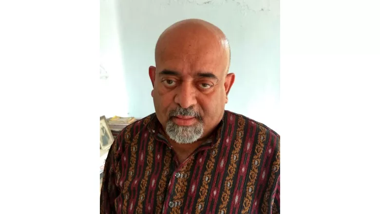 Picture of a man in a brown shirt