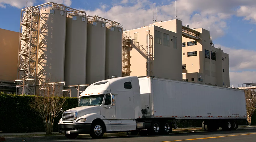 Big white truck outside a chemical facility. 