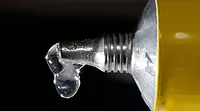 ASI0925-Web-900x500-SuperGlue.jpg A close-up of a yellow tube with a drop of clear glue.