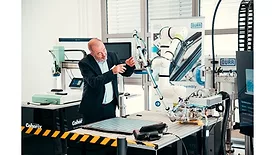 Picture of a man working on a machine.