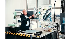 Picture of a man working on a machine.