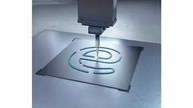 Picture of silicon being dispensed on a metal plate