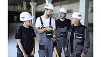 Picture of three men and one woman in white hardhats