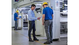 Picture of two men in hard hats at a manufacturing facility