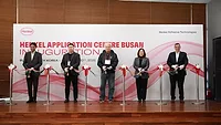 Picture of five people standing at a ribbon-cutting ceremony