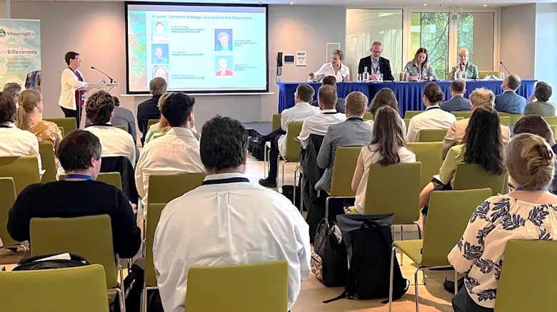 Picture of people in a room listening to speakers