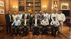Picture of men standing and sitting for a group photo