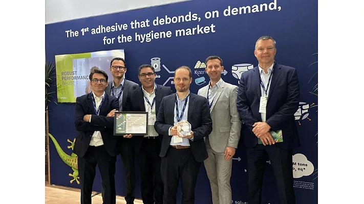 Picture of six men in suits with one man holding an award